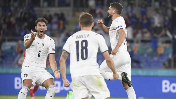 Italy's Manuel Locatelli, left, celebrates with Italy's Nicolo Barella, center, and Italy's Domenico Berardi after Turkey's Merih Demiral scores an own goal during the Euro 2020 soccer championship group A match between Italy and Turkey at the Olympic stadium in Rome, Friday, June 11, 2021. (Alberto Lingria/Pool Photo via AP)