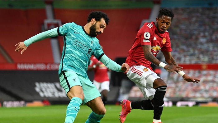 MANCHESTER, ENGLAND - MAY 13: Mohamed Salah of Liverpool battles for possession with Fred of Manchester United during the Premier League match between Manchester United and Liverpool at Old Trafford on May 13, 2021 in Manchester, England. Sporting stadiums around the UK remain under strict restrictions due to the Coronavirus Pandemic as Government social distancing laws prohibit fans inside venues resulting in games being played behind closed doors. (Photo by Michael Regan/Getty Images)