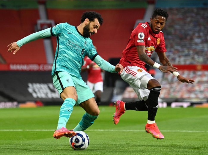 MANCHESTER, ENGLAND - MAY 13: Mohamed Salah of Liverpool battles for possession with Fred of Manchester United during the Premier League match between Manchester United and Liverpool at Old Trafford on May 13, 2021 in Manchester, England. Sporting stadiums around the UK remain under strict restrictions due to the Coronavirus Pandemic as Government social distancing laws prohibit fans inside venues resulting in games being played behind closed doors. (Photo by Michael Regan/Getty Images)