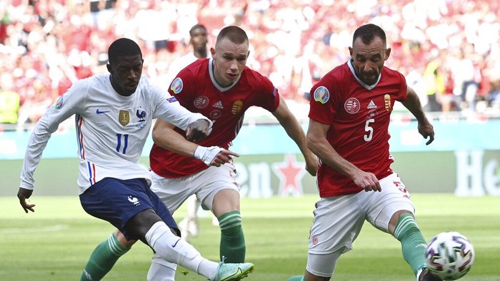 Frances Ousmane Dembele, left, takes a shot during the Euro 2020 soccer championship group F match between Hungary and France at the Ferenc Puskas stadium in Budapest, Hungary Saturday, June 19, 2021. (Tibor Illyes/Pool via AP)