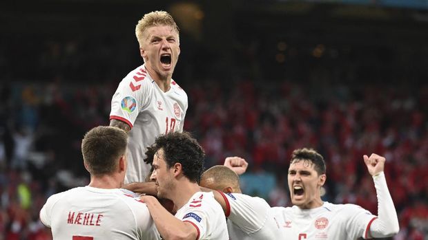 Denmark players celebrate after Mikkel Damsgaard scored his side's opening goal during the Euro 2020 soccer championship group B match between Russia and Denmark at the Parken stadium in Copenhagen, Denmark, Monday, June 21, 2021. (Jonathan Nackstrand/Pool via AP)