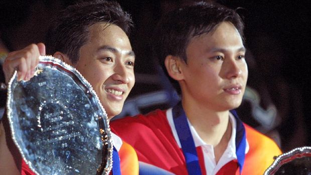 Indonesia's Halim Haryanto (L) and Tony Gunawan hold their trophies after winning the men's doubles final match against fellow countrymen Sigit Budiarto  and Candra Wijaya 11 March 2001, at the the All England Badminton Championships in Birmingham. Haryanto and Gunawan won the match 15-13,  7-15, 15-7.   AFP PHOTO/ADRIAN DENNIS (Photo by ADRIAN DENNIS / AFP)
