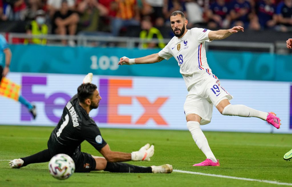 France's Karim Benzema, right, kicks the ball past Portugal's goalkeeper Rui Patricio to score his team's second goal during the Euro 2020 soccer championship group F match between Portugal and France at the Puskas Arena, Budapest, Hungary, Wednesday, June 23, 2021. (AP Photo/Darko Bandic,Pool)