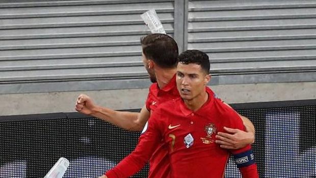 Portugal's forward Cristiano Ronaldo celebrates with teammates after scoring the team's second goal from the penalty spot during the UEFA EURO 2020 Group F football match between Portugal and France at Puskas Arena in Budapest on June 23, 2021. (Photo by Laszlo Balogh / POOL / AFP)