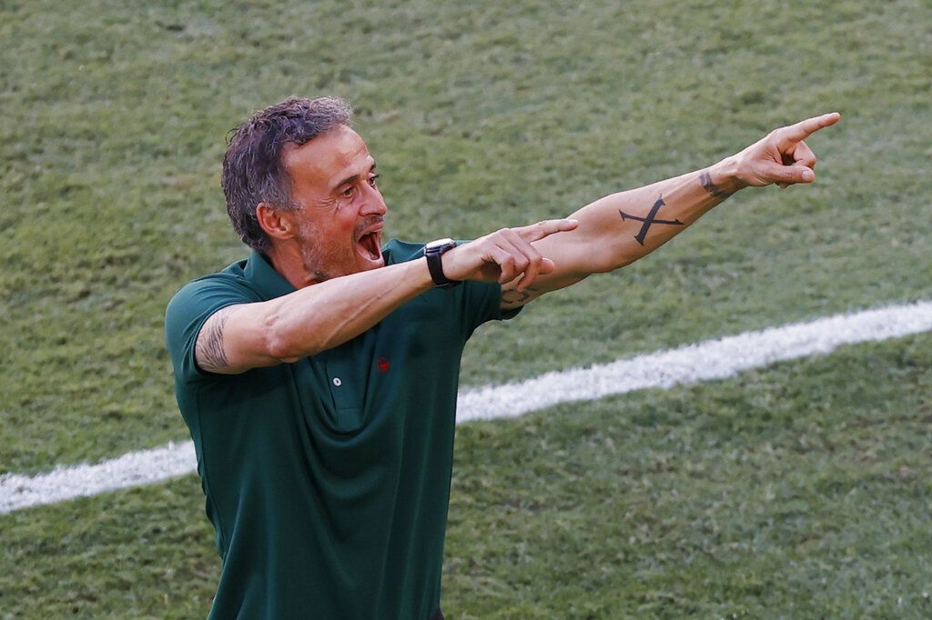 Spain's manager Luis Enrique celebrates after Spain's Aymeric Laporte scored his side's second goal during the Euro 2020 soccer championship group E match between Slovakia and Spain at La Cartuja Stadium in Seville, Spain, Wednesday June. 23, 2021. (Julio Munoz, Pool Photo via AP)