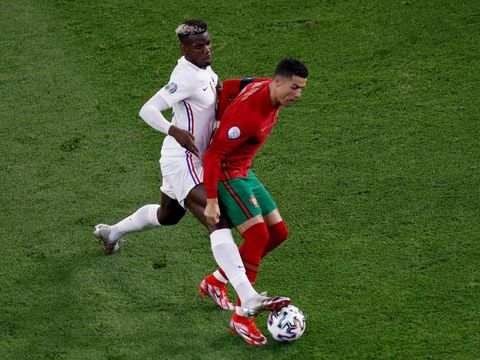 BUDAPEST, HUNGARY - JUNE 23: Cristiano Ronaldo of Portugal is challenged by Paul Pogba of France during the UEFA Euro 2020 Championship Group F match between Portugal and France at Puskas Arena on June 23, 2021 in Budapest, Hungary. (Photo by Laszlo Balogh - Pool/Getty Images)
