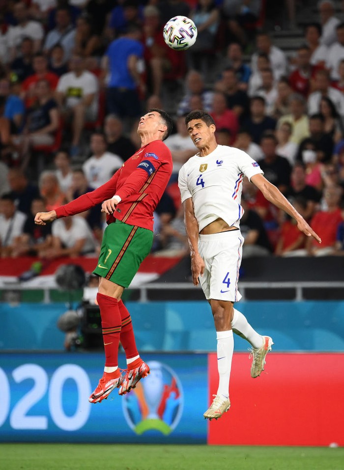 BUDAPEST, HUNGARY - JUNE 23: Karim Benzema of France interacts with Cristiano Ronaldo of Portugal during the UEFA Euro 2020 Championship Group F match between Portugal and France at Puskas Arena on June 23, 2021 in Budapest, Hungary. (Photo by Tibor Illyes - Pool/Getty Images)
