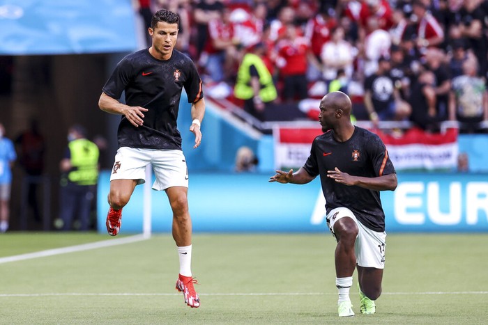 Cristiano Ronaldo Portugal's Cristiano Ronaldo, left, and teammate Danilo Pereira warm up prior the Euro 2020 soccer championship group F match between Hungary and Portugal at the Ferenc Puskas stadium in Budapest, Hungary, Tuesday, June 15, 2021. (Bernadett Szabo/Pool via AP)