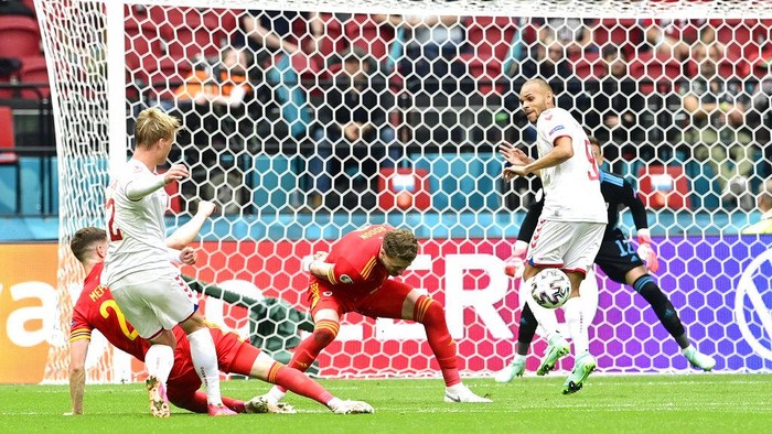 Denmarks Kasper Dolberg, left, scores his sides opening goal during the Euro 2020 soccer championship round of 16 match between Wales and Denmark at Johan Cruyff ArenA in Amsterdam, Netherlands, Saturday, June 26, 2021. (Olaf Kraak/Pool via AP)