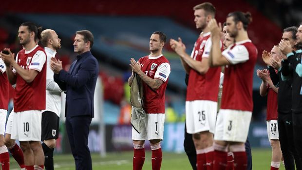 Austria's Marko Arnautovic, center, looks disappointed beside his teammates after losing the Euro 2020 soccer championship round of 16 match between Italy and Austria at Wembley stadium in London, Saturday, June 26, 2021. (Catherine Ivill/Pool via AP)