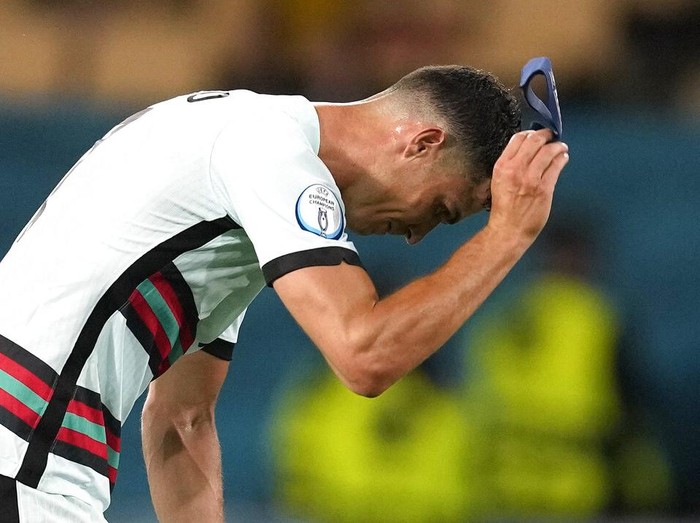 Portugal's Cristiano Ronaldo reacts after his team lost the Euro 2020 soccer championship round of 16 match between Belgium and Portugal at the La Cartuja stadium in Seville, Spain,Sunday, June 27, 2021. (AP Photo/Thanassis Stavrakis, Pool)