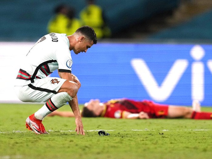Portugal's Cristiano Ronaldo reacts during the Euro 2020 soccer championship round of 16 match between Belgium and Portugal at the La Cartuja stadium in Seville, Spain,Sunday, June 27, 2021. (AP Photo/Thanassis Stavrakis, Pool)