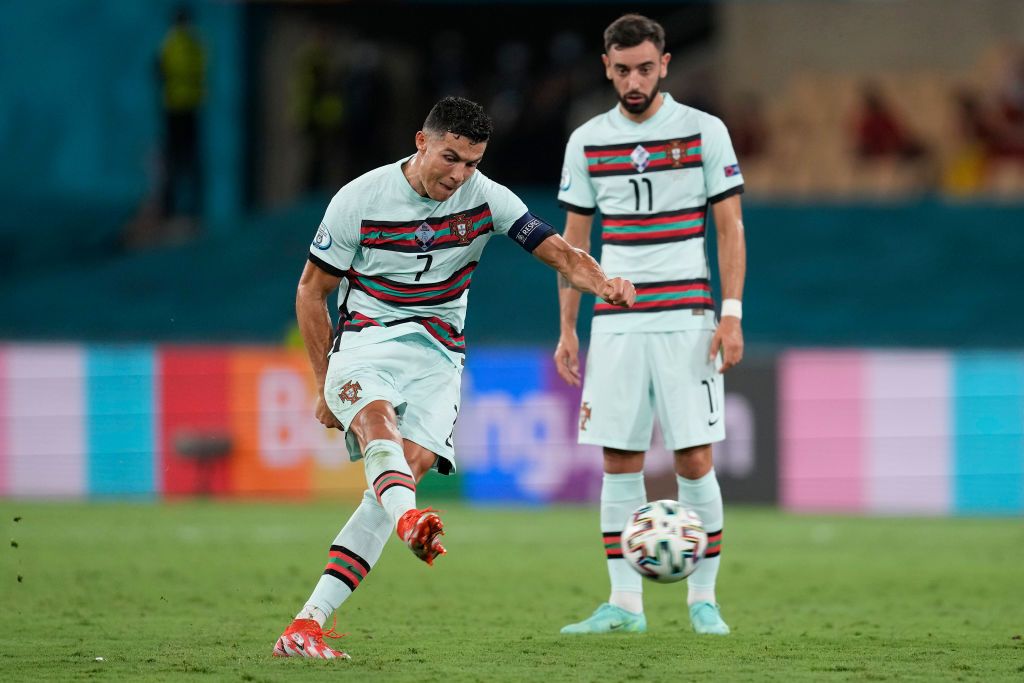 SEVILLE, SPAIN - JUNE 27: Cristiano Ronaldo of Portugal takes a free kick during the UEFA Euro 2020 Championship Round of 16 match between Belgium and Portugal at Estadio La Cartuja on June 27, 2021 in Seville, Spain. (Photo by Thanassis Stavrakis - Pool/UEFA via Getty Images)