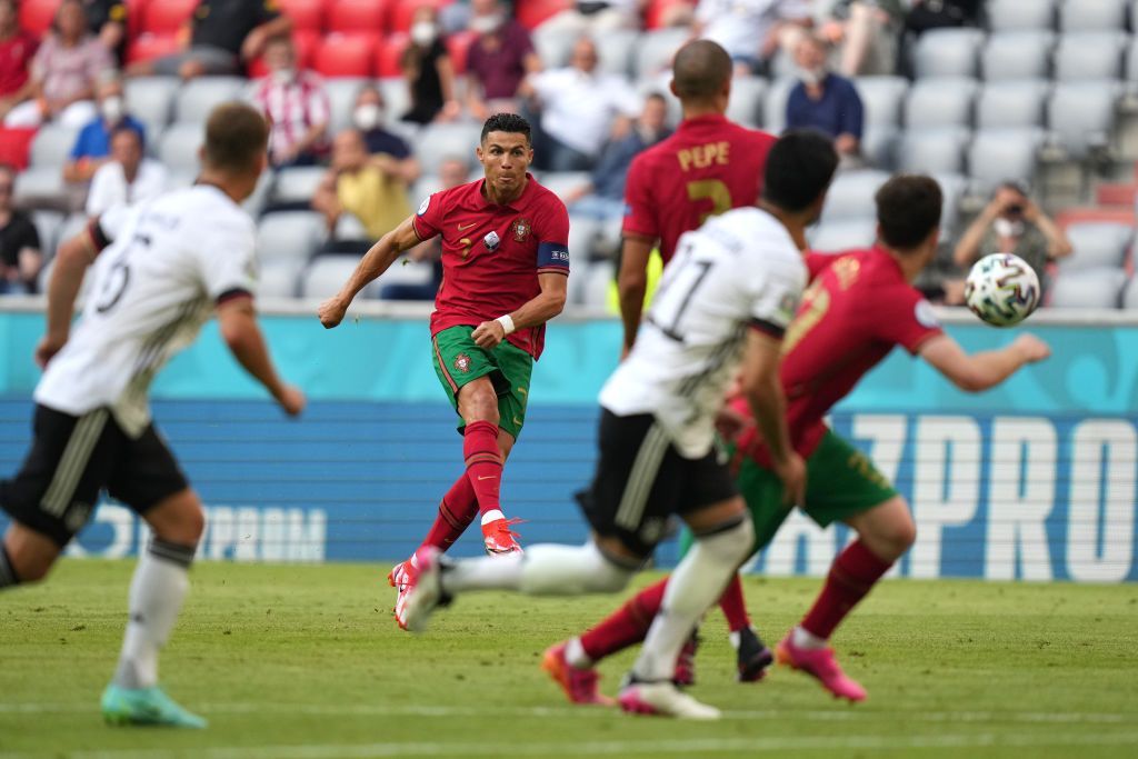 SEVILLE, SPAIN - JUNE 27: Cristiano Ronaldo of Portugal takes a free kick during the UEFA Euro 2020 Championship Round of 16 match between Belgium and Portugal at Estadio La Cartuja on June 27, 2021 in Seville, Spain. (Photo by Thanassis Stavrakis - Pool/UEFA via Getty Images)