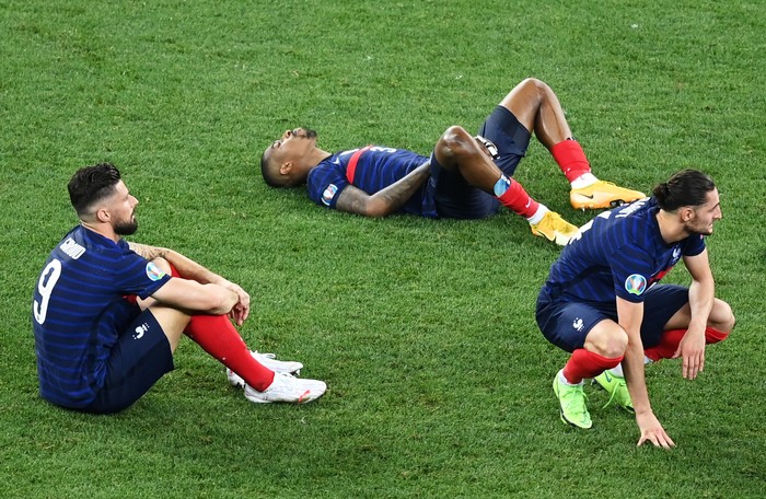 BUCHAREST, ROMANIA - JUNE 28: (L - R) Olivier Giroud, Presnel Kimpembe and Adrien Rabiot of France look dejected after losing in the penalty shoot out in the UEFA Euro 2020 Championship Round of 16 match between France and Switzerland at National Arena on June 28, 2021 in Bucharest, Romania. (Photo by Mihai Barbu - Pool/Getty Images)