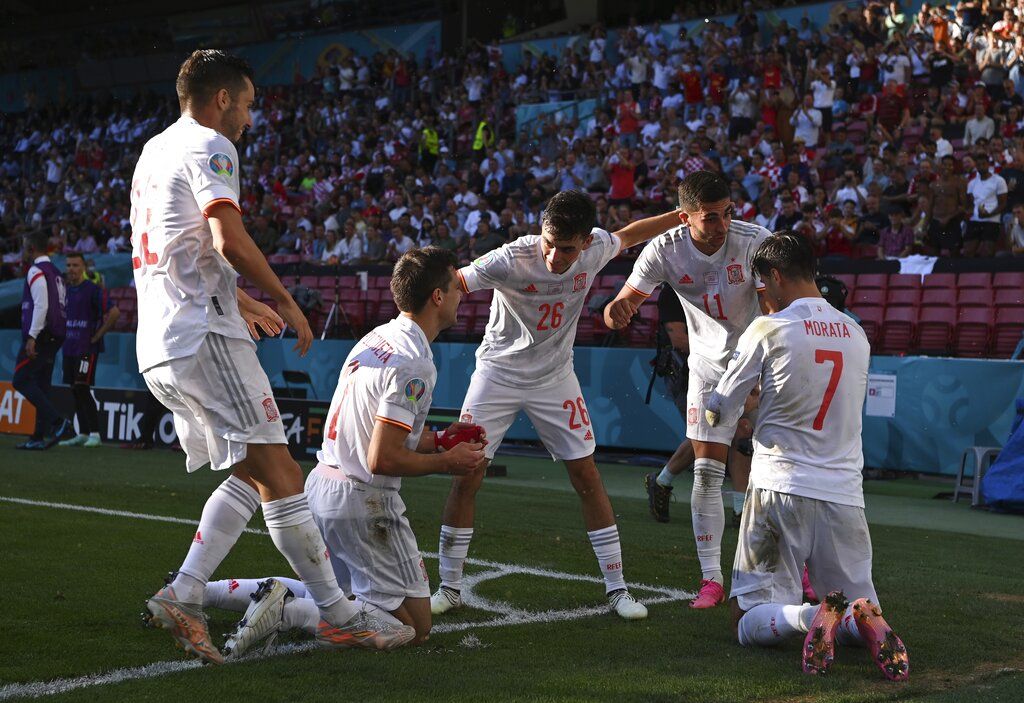 Spain's Cesar Azpilicueta, second left, celebrates after scoring his side's second goal during the Euro 2020 soccer championship round of 16 match between Croatia and Spain at Parken stadium in Copenhagen, Denmark, Monday, June 28, 2021.(AP Photo/Jonathan Nackstrand, Pool)