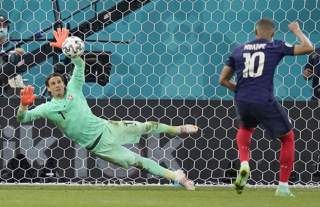 Switzerland's goalkeeper Yann Sommer saves the penalty shot by France's Kylian Mbappe during the Euro 2020 soccer championship round of 16 match between France and Switzerland at the National Arena stadium in Bucharest, Romania, Tuesday, June 29, 2021. (AP Photo/Vadim Ghirda, Pool)