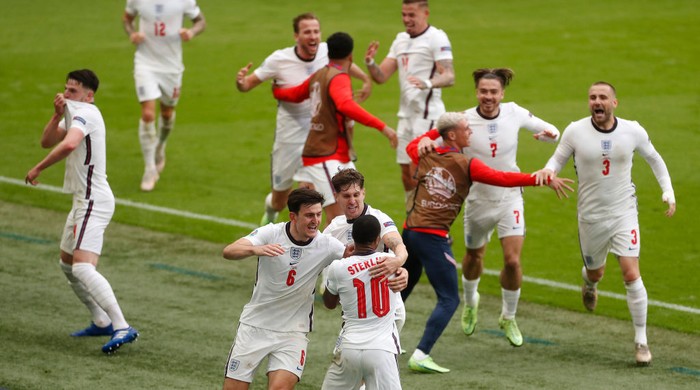 LONDON, ENGLAND - JUNE 29: Raheem Sterling of England celebrates with Harry Maguire and John Stones and team mates after scoring their sides first goal during the UEFA Euro 2020 Championship Round of 16 match between England and Germany at Wembley Stadium on June 29, 2021 in London, England. (Photo by Matthew Childs - Pool/Getty Images)