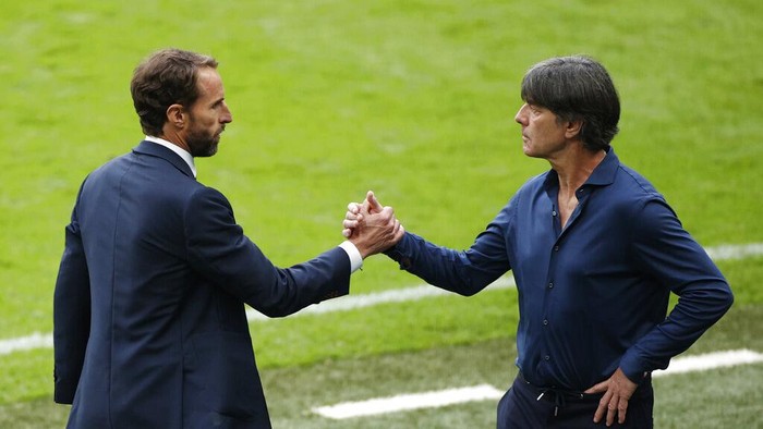 England's manager Gareth Southgate, left, shakes hands with Germany's manager Joachim Loew at the end of the Euro 2020 soccer match round of 16 between England and Germany at Wembley stadium in London, Tuesday, June 29, 2021. (John Sibley/Pool via AP)