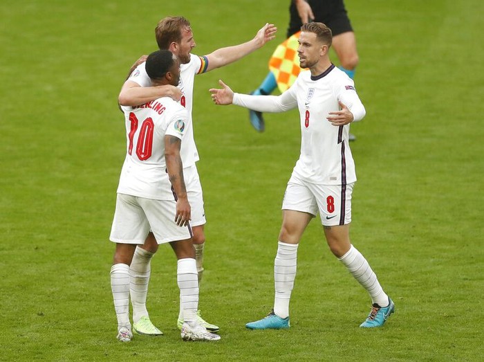 Englands Raheem Sterling, left, Harry Kane, center, scorers of the two goals celebrate with Jordan Henderson after the Euro 2020 soccer championship round of 16 match between England and Germany, at Wembley stadium, in London, Tuesday, June 29, 2021. England won 2-0. (Matthew Childs/Pool via AP)