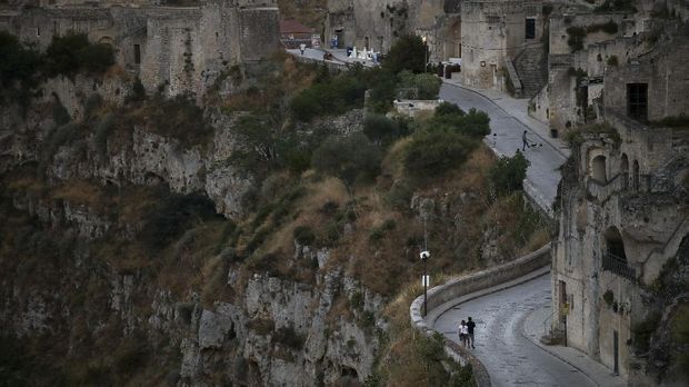 Keajaiban Kota Matera di Italia People walk on the street of the 'Sassi di Matera' districts, in Matera, Italy, June 29, 2021. Picture taken June 29, 2021. REUTERS/Yara Nardi