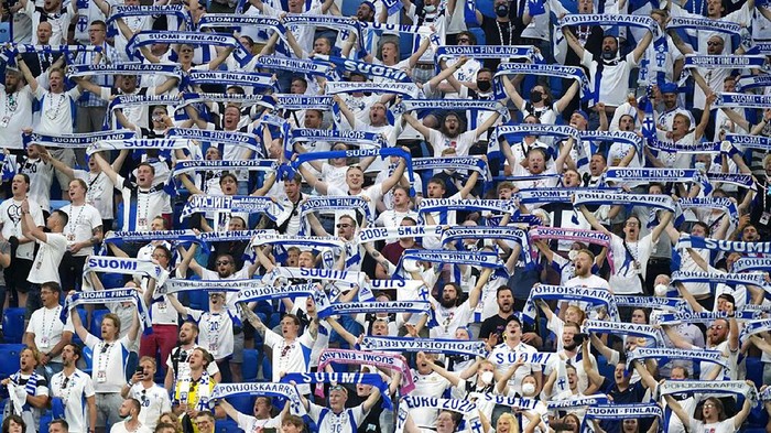 Fans of Finland sing the national anthem of their country before the Euro 2020 soccer championship group B match between Finland and Belgium at Saint Petersburg stadium, in St. Petersburg, Russia, Monday, June 21, 2021. (AP Photo/Dmitri Lovetsky, Pool)