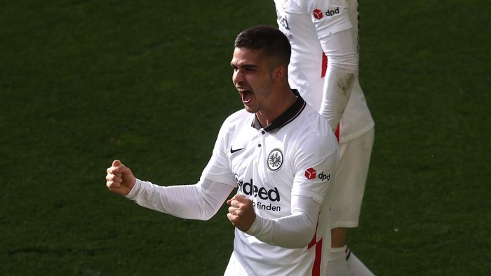 DORTMUND, GERMANY - APRIL 03: Andre Silva of Eintracht Frankfurt celebrates after scoring their sides second goal as during the Bundesliga match between Borussia Dortmund and Eintracht Frankfurt at Signal Iduna Park on April 03, 2021 in Dortmund, Germany. Sporting stadiums around Germany remain under strict restrictions due to the Coronavirus Pandemic as Government social distancing laws prohibit fans inside venues resulting in games being played behind closed doors. (Photo by Lars Baron/Getty Images)