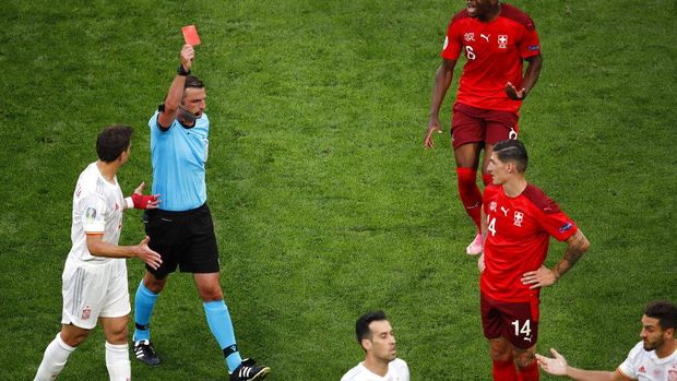 Referee shows a red card to Switzerland's Remo Freuler, not pictured, during the Euro 2020 soccer championship quarterfinal match between Switzerland and Spain at Saint Petersburg Stadium in St. Petersburg, Russia, Friday, July 2, 2021. (Anton Vaganov/Pool via AP)