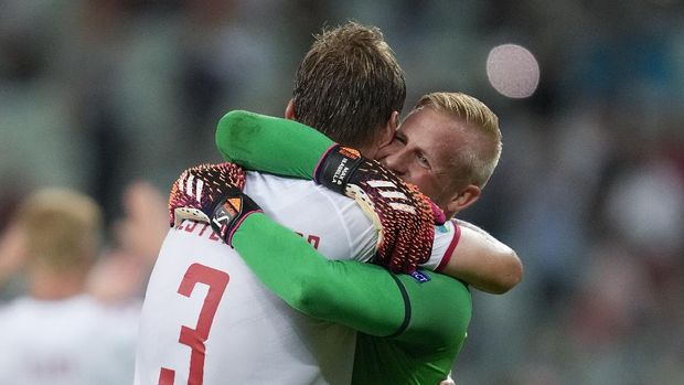 Denmark's goalkeeper Kasper Schmeichel, right, hugs Jannik Vestergaard at the end of the Euro 2020 soccer championship quarterfinal match between Czech Republic and Denmark, at the Olympic stadium in Baku, Saturday, July 3, 2021. Denmark won 2-1 and advances to the semifinals. (AP Photo/Darko Vojinovic, Pool)
