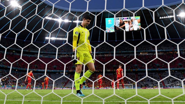 MUNICH, GERMANY - JULY 02: Thibaut Courtois of Belgium looks dejected after the Italy first goal scored by Nicolo Barella during the UEFA Euro 2020 Championship Quarter-final match between Belgium and Italy at Football Arena Munich on July 02, 2021 in Munich, Germany. (Photo by Matthias Hangst/Getty Images)
