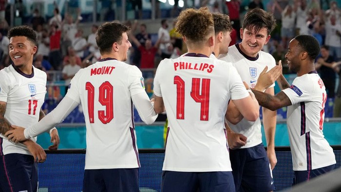 ROME, ITALY - JULY 03: Harry Maguire of England celebrates with John Stones and Raheem Sterling after scoring their sides second goal during the UEFA Euro 2020 Championship Quarter-final match between Ukraine and England at Olimpico Stadium on July 03, 2021 in Rome, Italy. (Photo by Alessandra Tarantino - Pool/Getty Images)