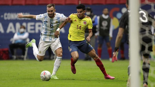 Colombia's Luis Diaz, right, battles for the ball with Argentina's German Pezzella before scoring his side's opening goal during a Copa America semifinal soccer match at the National stadium in Brasilia, Brazil, Tuesday, July 6, 2021. (AP Photo/Eraldo Peres)