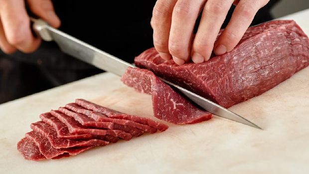 Japanese man slicing meat