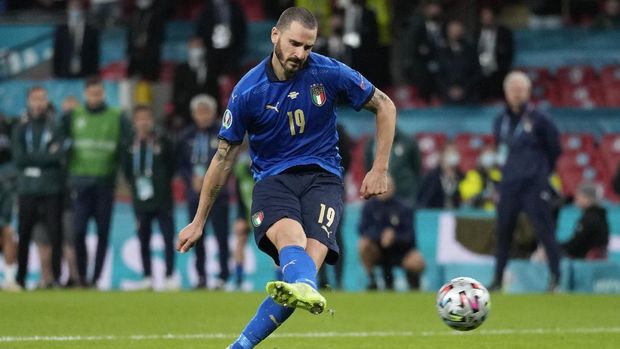 Italy's Leonardo Bonucci scores during the penalty shootout during the Euro 2020 soccer semifinal match between Italy and Spain at Wembley stadium in London, Tuesday, July 6, 2021. (AP Photo/Frank Augstein, Pool)