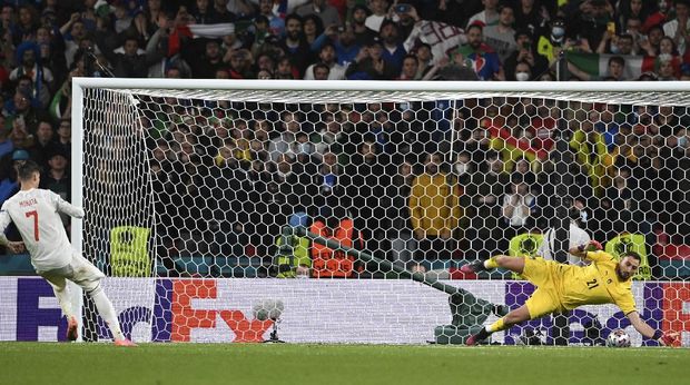 Italy's goalkeeper Gianluigi Donnarumma, right, makes a save against Spain's Alvaro Morata during the penalty shootout of the Euro 2020 soccer championship semifinal match between Italy and Spain at Wembley Stadium in London, Tuesday, July 6, 2021. (Andy Rain/Pool via AP)