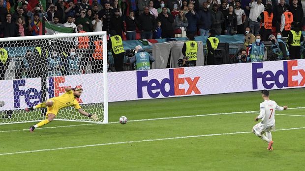 Italy's goalkeeper Gianluigi Donnarumma stops a penalty shot from Spain's Alvaro Morata during a penalty shootout at the end of during the Euro 2020 soccer championship semifinal match between Italy and Spain at Wembley stadium in London, Tuesday, July 6, 2021. (Facundo Arrizabalaga/Pool Photo via AP)