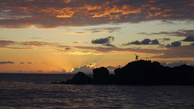 Black Rock, a jetty that Hawaiians once thought was place spirits of the deceased ascended to the spirit world. Tourists like to jump off the haunted mass of rocks. Kaanapali Beach, Maui, Hawaii.