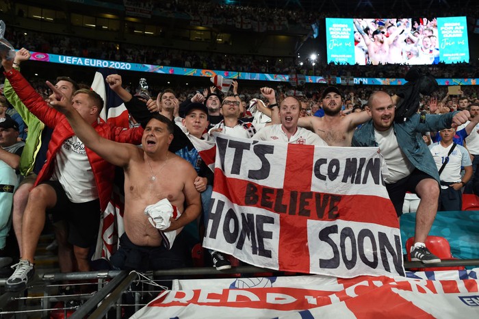 LONDON, ENGLAND - JULY 07: Fans of England celebrate their sides victory after the UEFA Euro 2020 Championship Semi-final match between England and Denmark at Wembley Stadium on July 07, 2021 in London, England. (Photo by Paul Ellis - Pool/Getty Images)