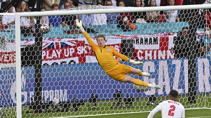 Englands goalkeeper Jordan Pickford is airborne as he fails to stop a goal from Denmarks Mikkel Damsgaard during the Euro 2020 soccer championship semifinal between England and Denmark at Wembley stadium in London, Wednesday, July 7, 2021. (Justin Tallis/Pool Photo via AP)