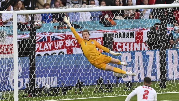England's goalkeeper Jordan Pickford is airborne as he fails to stop a goal from Denmark's Mikkel Damsgaard during the Euro 2020 soccer championship semifinal between England and Denmark at Wembley stadium in London, Wednesday, July 7, 2021. (Justin Tallis/Pool Photo via AP)
