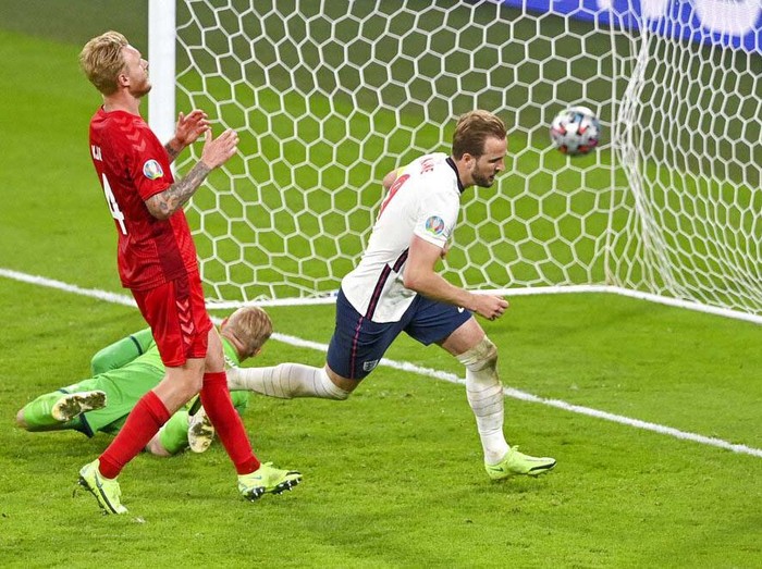 England's Harry Kane, right, reacts after scoring his team's second goal during the Euro 2020 soccer championship semifinal between England and Denmark at Wembley stadium in London, Wednesday, July 7, 2021. (Justin Tallis/Pool Photo via AP)