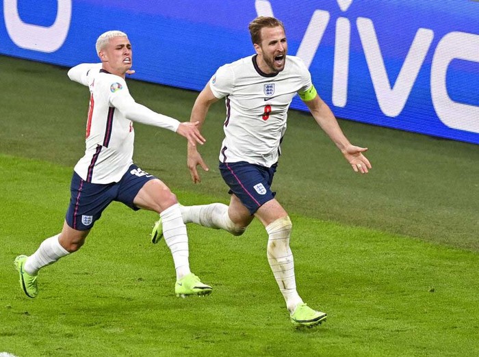 Englands Harry Kane, right, reacts after scoring his teams second goal during the Euro 2020 soccer championship semifinal between England and Denmark at Wembley stadium in London, Wednesday, July 7, 2021. (Justin Tallis/Pool Photo via AP)