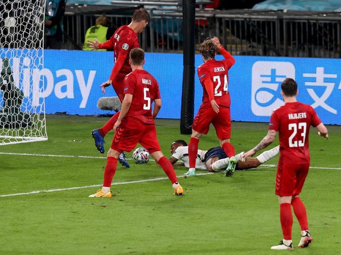 LONDON, ENGLAND - JULY 07: Raheem Sterling of England is fouled by Mathias Jensen of Denmark inside the penalty area, leading to England being awarded a penalty during the UEFA Euro 2020 Championship Semi-final match between England and Denmark at Wembley Stadium on July 07, 2021 in London, England. (Photo by Catherine Ivill/Getty Images)