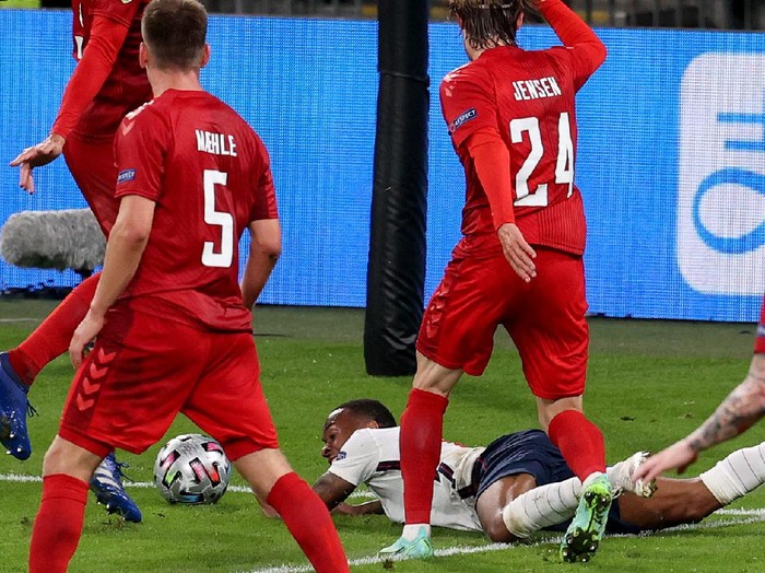 LONDON, ENGLAND - JULY 07: Raheem Sterling of England is fouled by Mathias Jensen of Denmark inside the penalty area, leading to England being awarded a penalty during the UEFA Euro 2020 Championship Semi-final match between England and Denmark at Wembley Stadium on July 07, 2021 in London, England. (Photo by Catherine Ivill/Getty Images)