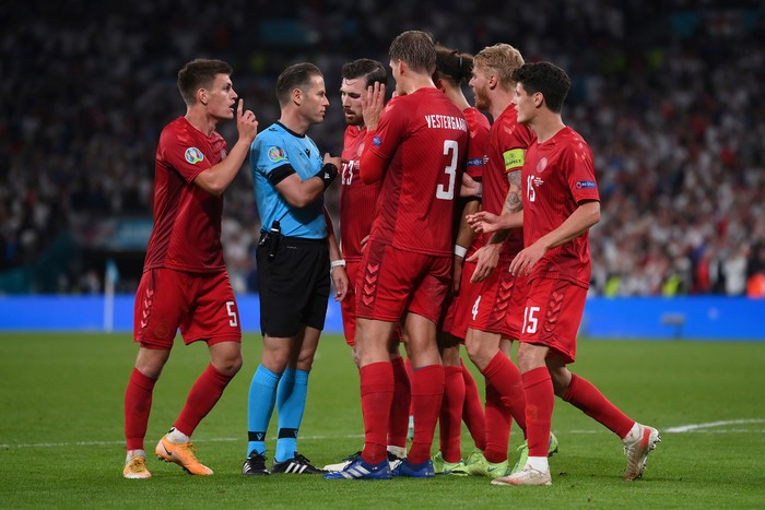 Raheem Sterling Denmark players argue with referee Danny Makkelie after he awarded a penalty to England's Raheem Sterling during the Euro 2020 soccer semifinal match between England and Denmark at Wembley stadium in London, Wednesday, July 7, 2021. (Laurence Griffiths/Pool Photo via AP)