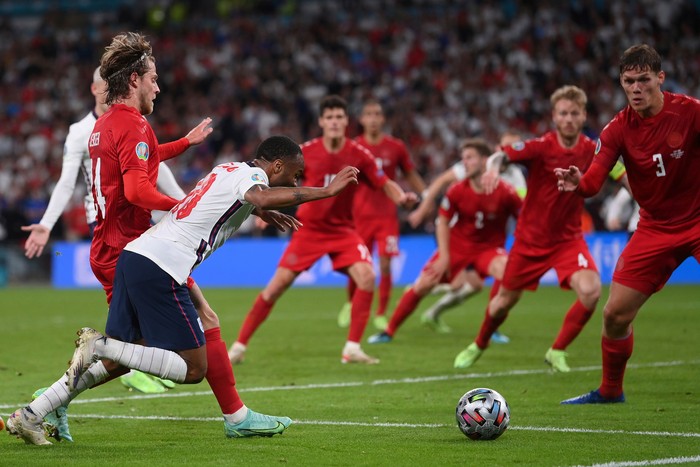 England's Raheem Sterling, left, is fouled by Denmark's Mathias Jensen and a penalty is awarded during the Euro 2020 soccer semifinal match between England and Denmark at Wembley stadium in London, Wednesday, July 7, 2021. (Laurence Griffiths/Pool Photo via AP)