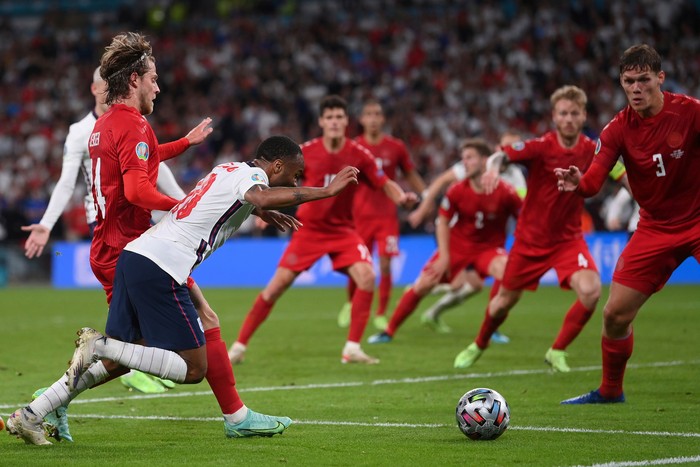 Raheem Sterling England's Raheem Sterling, left, is fouled by Denmark's Mathias Jensen and a penalty is awarded during the Euro 2020 soccer semifinal match between England and Denmark at Wembley stadium in London, Wednesday, July 7, 2021. (Laurence Griffiths/Pool Photo via AP)