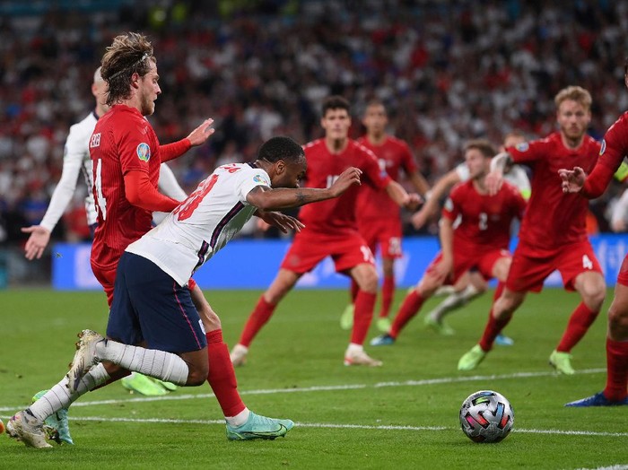 England's Raheem Sterling, left, is fouled by Denmark's Mathias Jensen and a penalty is awarded during the Euro 2020 soccer semifinal match between England and Denmark at Wembley stadium in London, Wednesday, July 7, 2021. (Laurence Griffiths/Pool Photo via AP)