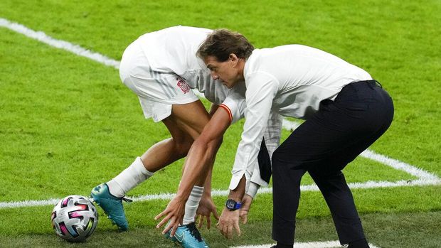 Italy's manager Roberto Mancini and Spain's Marcos Llorente both attempt to grab for the ball during the Euro 2020 soccer championship semifinal between Italy and Spain at Wembley stadium in London, Tuesday, July 6, 2021. (AP Photo/Matt Dunham,Pool)