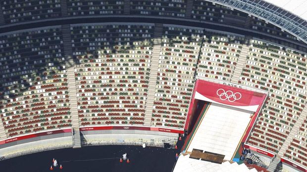 In this aerial photo, the Olympic Rings are seen with spectators' seats at the National Stadium in Tokyo Japan, Monday, June 21, 2021. Fans will be banned from Tokyo-area stadiums and arenas when the Olympics begin in two weeks, the city's governor said Thursday after meeting with organizers of the pandemic-postponed games.(Kyodo News via AP)
